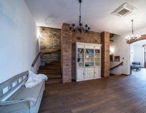 a living room with a staircase and a brick wall at Casa Kraus in Criţ