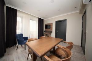 a dining room with a wooden table and chairs at Corner Suite in Istanbul