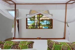 En eller flere senge i et værelse på Hodi Hodi Zanzibar