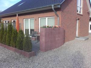 a brick house with a fence in front of it at Ferienwohnung Berger in Timmendorfer Strand