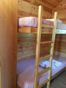 two bunk beds in a log cabin at Camping Forcanada in Era Bordeta