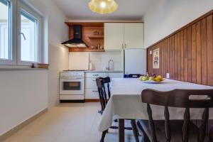 een keuken met een tafel en een fruitschaal bij Apartments Grancarić in Zadar