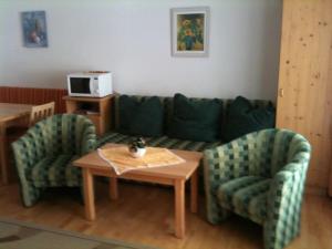 a living room with a couch and two chairs and a table at Haus König in Obergurgl