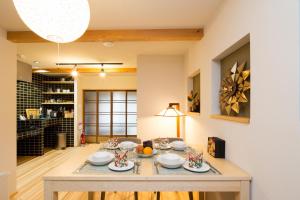 a dining room with a table with dishes on it at MACHIYA de HIGASHIYAMA in Kyoto
