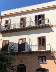 a white building with balconies and windows on it at Le Quattro Chiavi in Palermo +59 photos