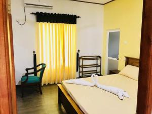 Postel nebo postele na pokoji v ubytování Ocean Gate Negombo
