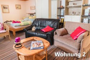ein Wohnzimmer mit einem Sofa und einem Tisch in der Unterkunft Ferienwohnung Küssner in Kiel