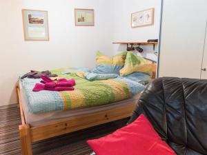 a bed in a room with a mirror at Ferienwohnung Küssner in Kiel