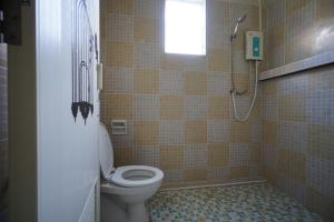 a bathroom with a toilet and a shower at Baan Malee in Phuket Town +23 photos