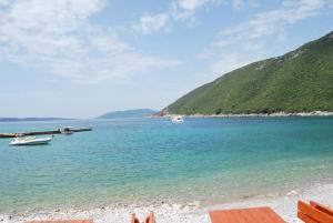 a beach with two boats in the water at Hotel Art Media in Herceg-Novi