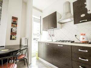 a kitchen with a sink and a stove top oven at Residenza Riva Reno - BOLOGNA in Bologna