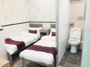 Postelja oz. postelje v sobi nastanitve Vve Vve Hotel