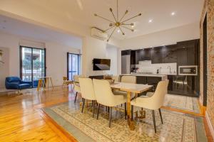 a dining room and living room with a table and chairs at Luxury Flats Madrid Center in Madrid