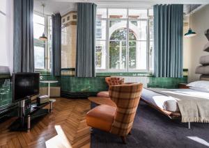 a bedroom with a bed and a chair and a tv at ABode Manchester in Manchester