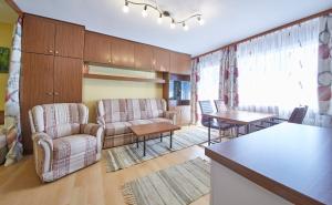 a living room with two chairs and a table at Appartement Active in Saalbach Hinterglemm