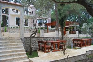 a group of tables and chairs in front of a building at Hotel Art Media in Herceg-Novi