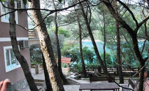 a view of a park with a bench and trees at Hotel Art Media in Herceg-Novi