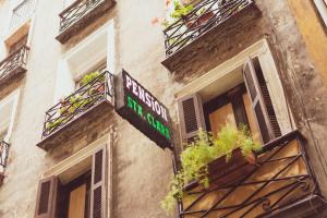 a building with a sign on the side of it at Pensión Santa Clara in Donostia-San Sebastián