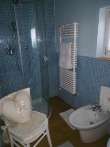 a bathroom with a shower and a toilet and a sink at Torretta sul Colle in Colle Umberto