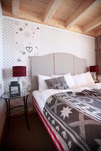 a bedroom with a bed and a side table with a lamp at Hamilton Lodge & Spa in Belalp +81 photos