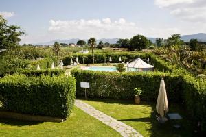 a garden with a swimming pool and a tent at Casale Dell'Orso in Pistoia