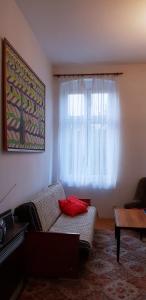 a living room with a couch and a window at Sweet Kato Apartment in Katowice