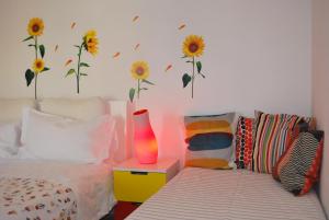 a bedroom with a bed and a vase on a side table at Appartamento Annurca in Naples