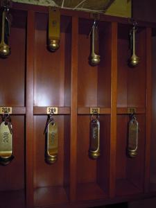 a row of wooden lockers with labels on them at Hotel 4 Mori in Cagliari