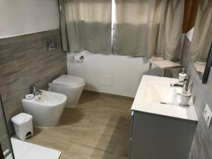 a bathroom with a toilet and a sink and a toilet istg at B&B Le Mansarde in Pescara