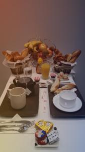 a table with food and other foods on it at Hotel la Perle Montparnasse in Paris