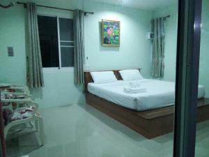 a bedroom with a bed and a window at Pakjai resort in Chaiyaphum
