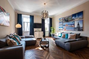 a living room with two couches and a table at Center,The Rumbach suite in Budapest