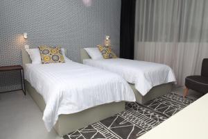 Postel nebo postele na pokoji v ubytování Hotel Cubis