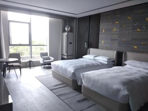 Postelja oz. postelje v sobi nastanitve Yunhe Yebo Hotel (Shanghai International Tourism Resort Pudong Airport)