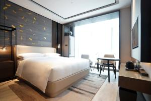 Postelja oz. postelje v sobi nastanitve Yunhe Yebo Hotel (Shanghai International Tourism Resort Pudong Airport)