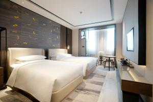 Postelja oz. postelje v sobi nastanitve Yunhe Yebo Hotel (Shanghai International Tourism Resort Pudong Airport)