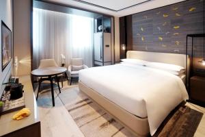 Postelja oz. postelje v sobi nastanitve Yunhe Yebo Hotel (Shanghai International Tourism Resort Pudong Airport)