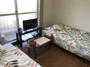 En eller flere senger på et rom på 京都パティオフィッツ Patiofits 403 #TT2