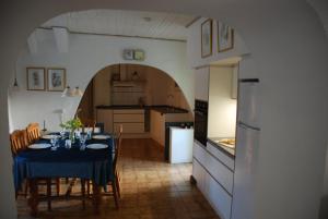 een keuken met een tafel met een blauwe tafeldoek bij Neffies Languedoc Frankrig in Néffiès