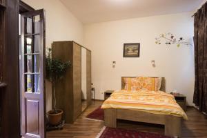 een slaapkamer met een bed en een houten kast bij Motor House Unirii in Boekarest