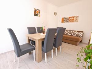 a dining room with a wooden table and chairs at House Smiljana 2059 in Vodnjan