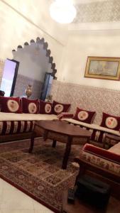 a living room with a couch and a mirror at Dar Soraya al Madina Marrakech in Marrakesh