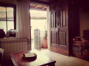 a room with a door and a table and a window at El Cuetu in Posada