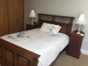a bedroom with a large bed with blue flowers on it at Carey's Bar & Farmhouse Kilkenny Border in Oldleighlin