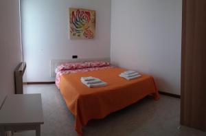 a bedroom with a bed with towels on it at Villa Susy in Desenzano del Garda +39 photos