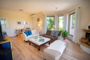 a living room with two couches and a coffee table at Villa Rodi in Katastárion