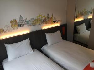 A bed or beds in a room at easyHotel Belfast