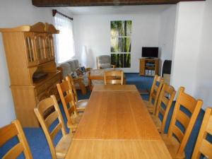 a dining room with a wooden table and chairs at Holiday Villa Herlikovice in Vrchlabí