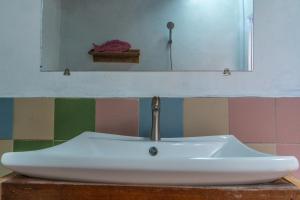 a bathroom sink with a faucet and a mirror at Lost and Found in Koh Rong Sanloem +33 photos