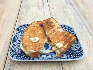 two grilled cheese sandwiches on a blue and white plate at Lost and Found in Koh Rong Sanloem